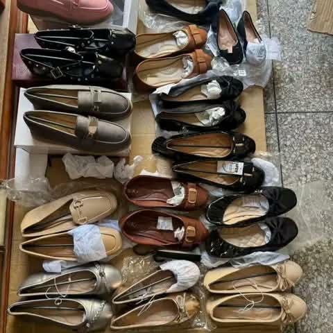 Assorted women's loafers and flat shoes.