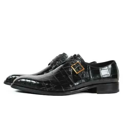 Black croc-pattern monk strap shoes with a gold buckle.
