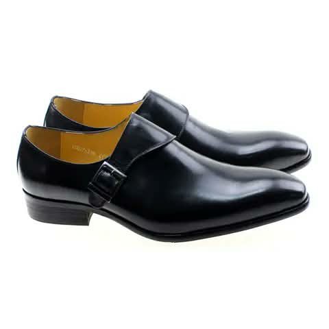 Black monk strap shoes with yellow lining.