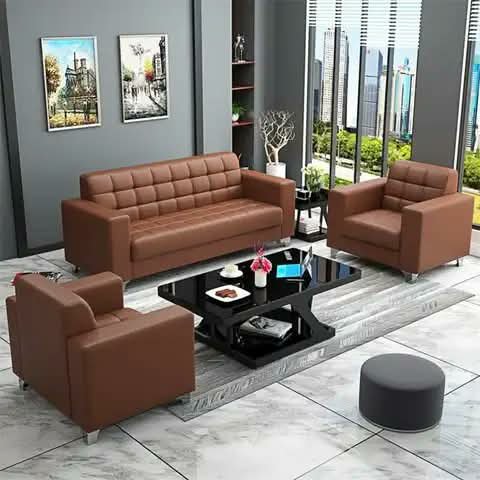 A brown leather sofa set with coffee table in an office.