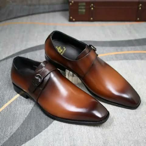 Brown monk strap shoes on a carpet.