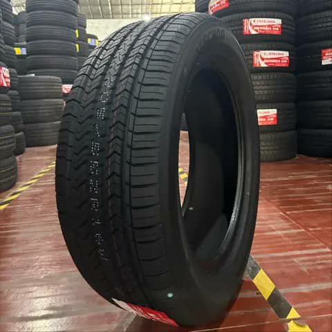 Single car tyre close-up on a red floor