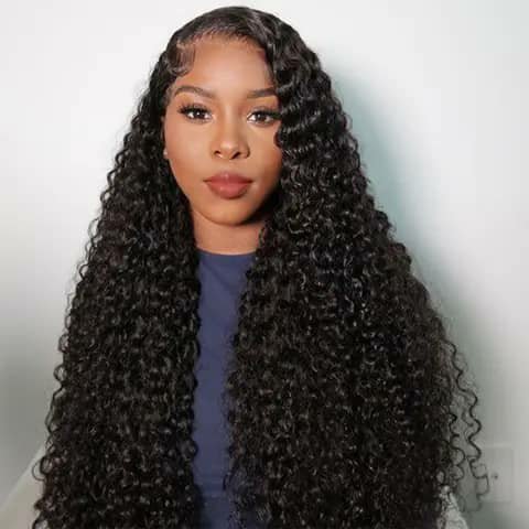 A woman wearing a very long black deep-wave wig.