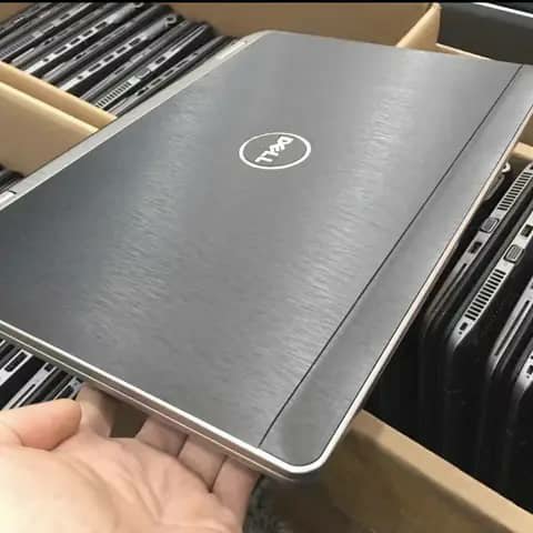 Dell laptop lid held up, dark brushed finish