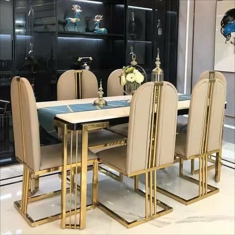 Dining table with six beige and gold chairs