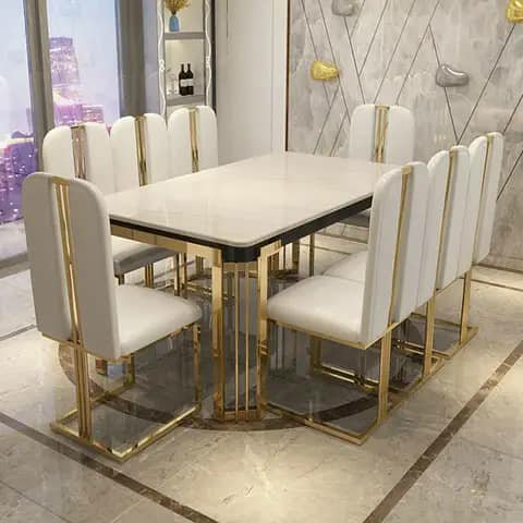 White dining table with gold-frame chairs
