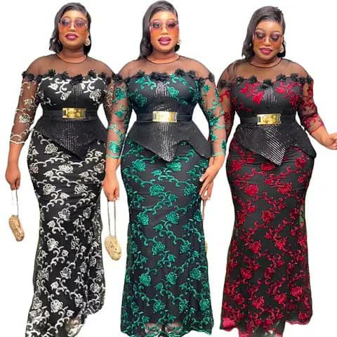 Three women wearing long lace mermaid dresses with gold belts in black with white lace, black with green lace, and black with red lace.