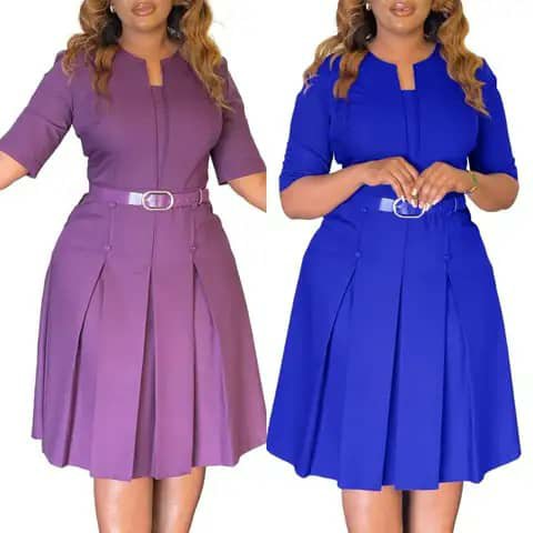Two women wearing belted pleated dresses in mauve and royal blue.