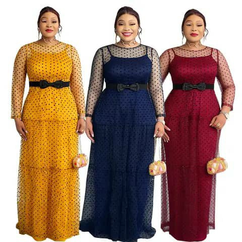 Three women wearing long polka-dot mesh dresses in yellow, navy and burgundy with black bow belts.