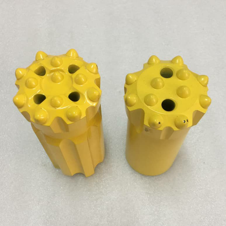Two yellow drill bits on white foam.