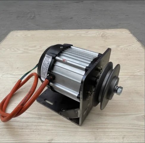 Silver ribbed dynamo with pulley wheel and orange cable on a base