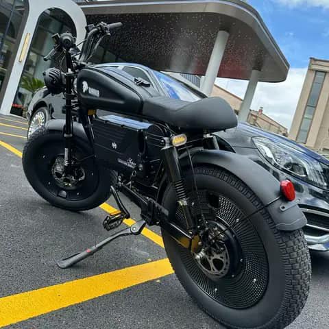 Black fat-tyre electric bike parked in a lot