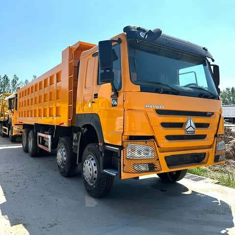 Orange HOWO dump truck parked outdoors