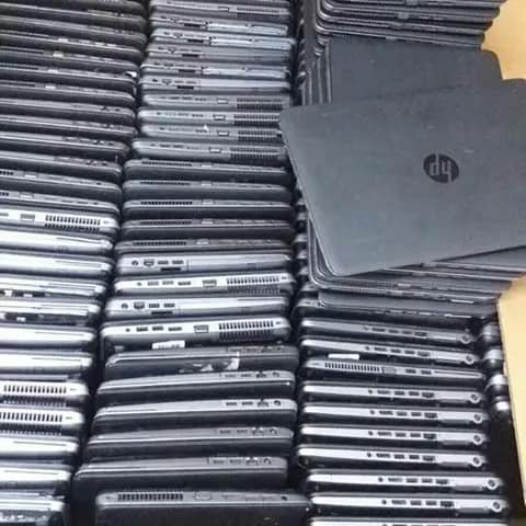 Stacks of black HP laptops, bulk stock