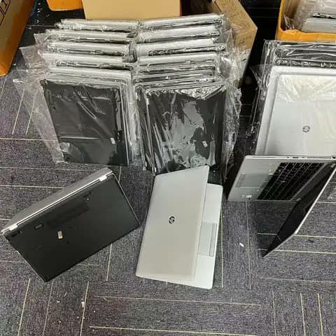 HP laptops wrapped in plastic, in black and silver