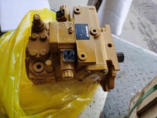 A small tan hydraulic pump resting on yellow plastic.