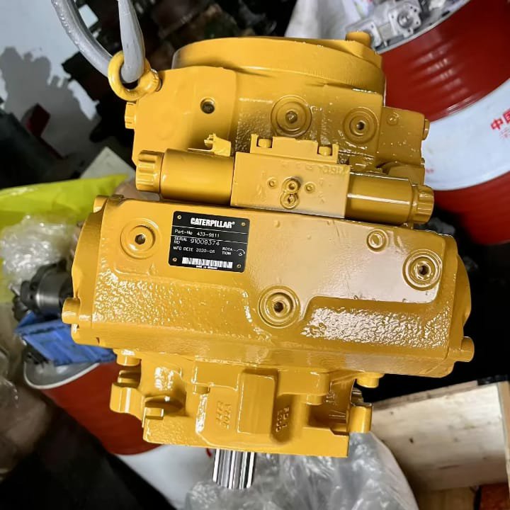 A large yellow hydraulic pump with a Caterpillar plate on its side.