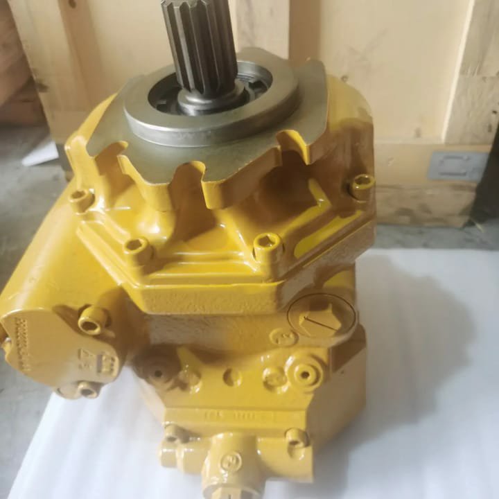 A top view of a yellow hydraulic pump with a splined shaft.