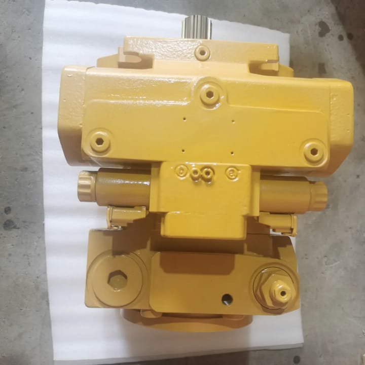 An underside view of a yellow hydraulic pump on white cloth.