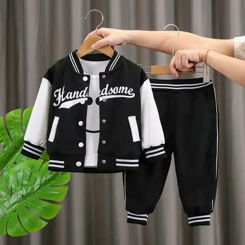 A kids' tracksuit set — varsity jacket and joggers in black and white.