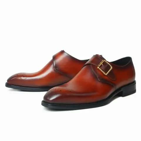 Red-brown monk strap shoes with a gold buckle.