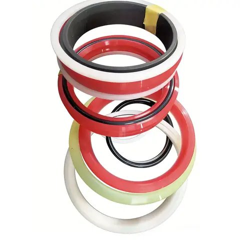 A stack of hydraulic seal rings in red, white, black and green.
