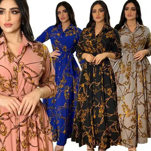 Four women wearing long chain-print shirt dresses in pink, blue, black and beige.