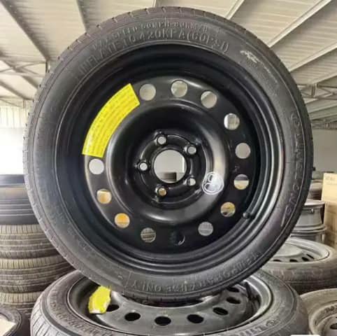 Black spare steel wheel with tyre