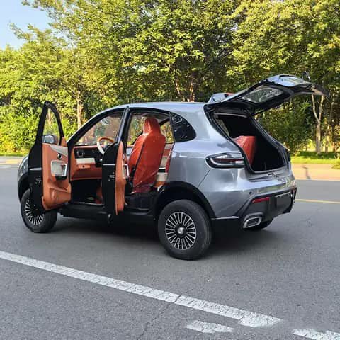 Silver SUV with doors and boot open, orange interior