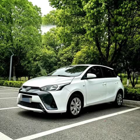 White Toyota Yaris hatchback parked outdoors
