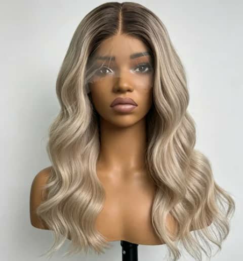 A long wavy ash-blonde wig on a mannequin head.