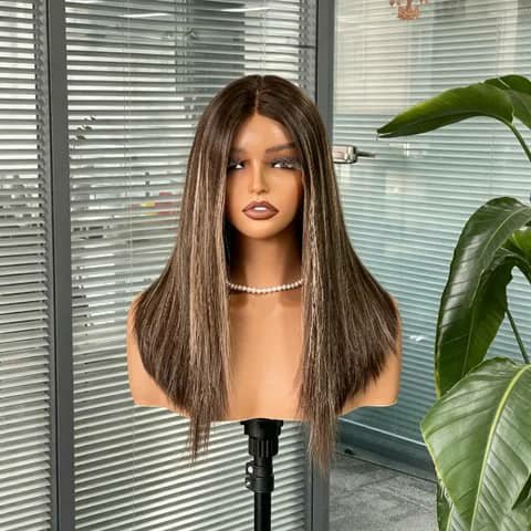 A mannequin head wearing a shoulder-length straight brown wig with blonde highlights.