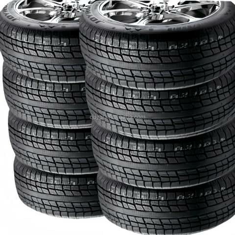 Two stacks of winter tyres with rims