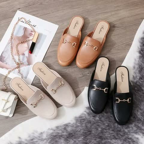 Women's mule loafers in tan, cream and black.
