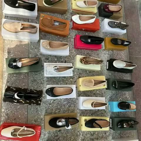 Women's shoes displayed on their boxes, assorted styles.